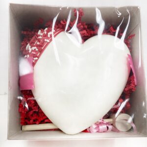 Small breakable white chocolate heart with candy inside
